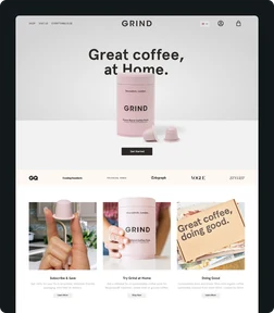 Grind coffee homepage with a pink coffee tin and product photography